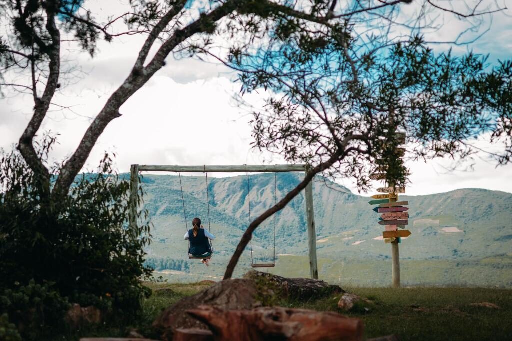 A swing under a tree on the ridge at Samaipata, looking out at the mountains
