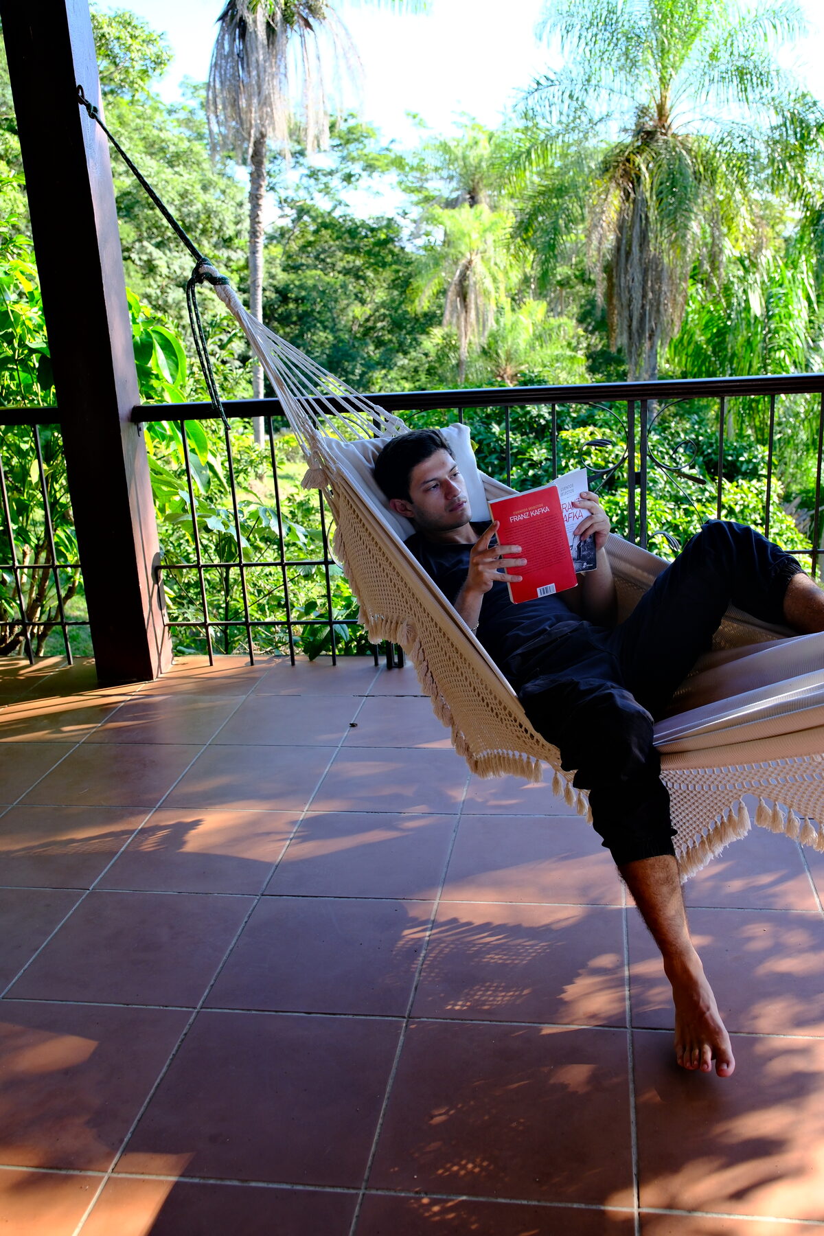 A guest reading in a hammock in the afternoon