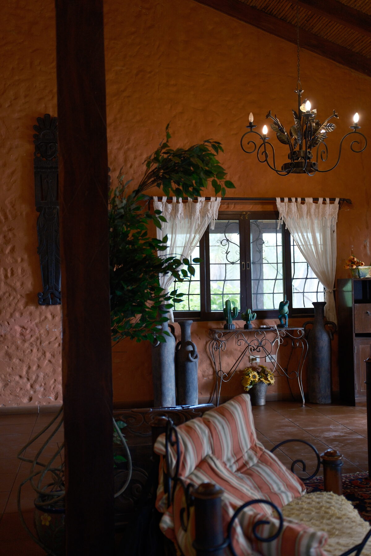A warm adobe sitting room, plants and low lamplight