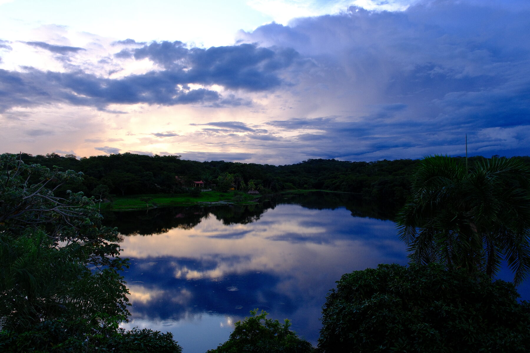The lake below the town at dusk, cloud reflected in still water