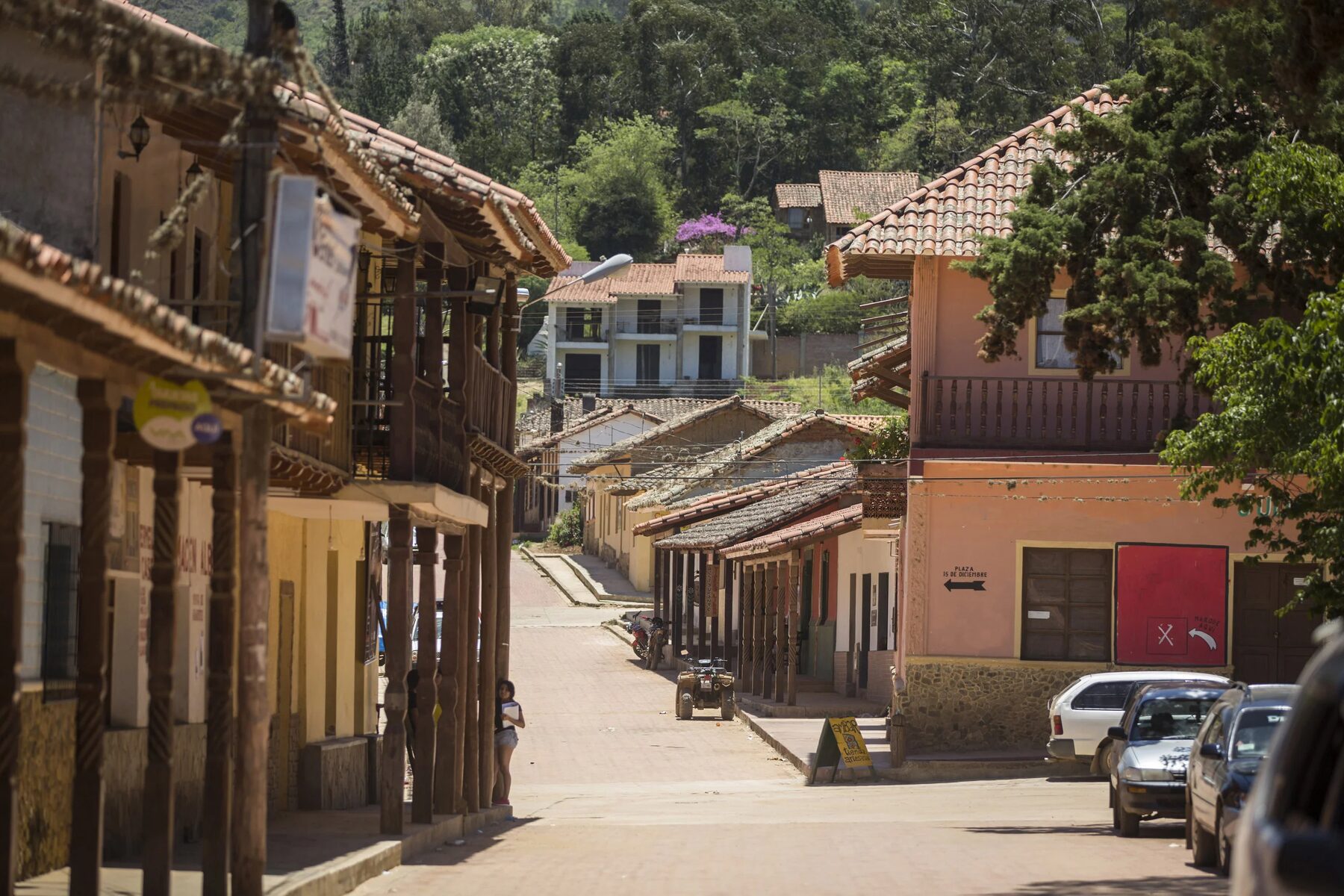 The main street of Samaipata in the middle of the day, tiled roofs and wooden colonnades