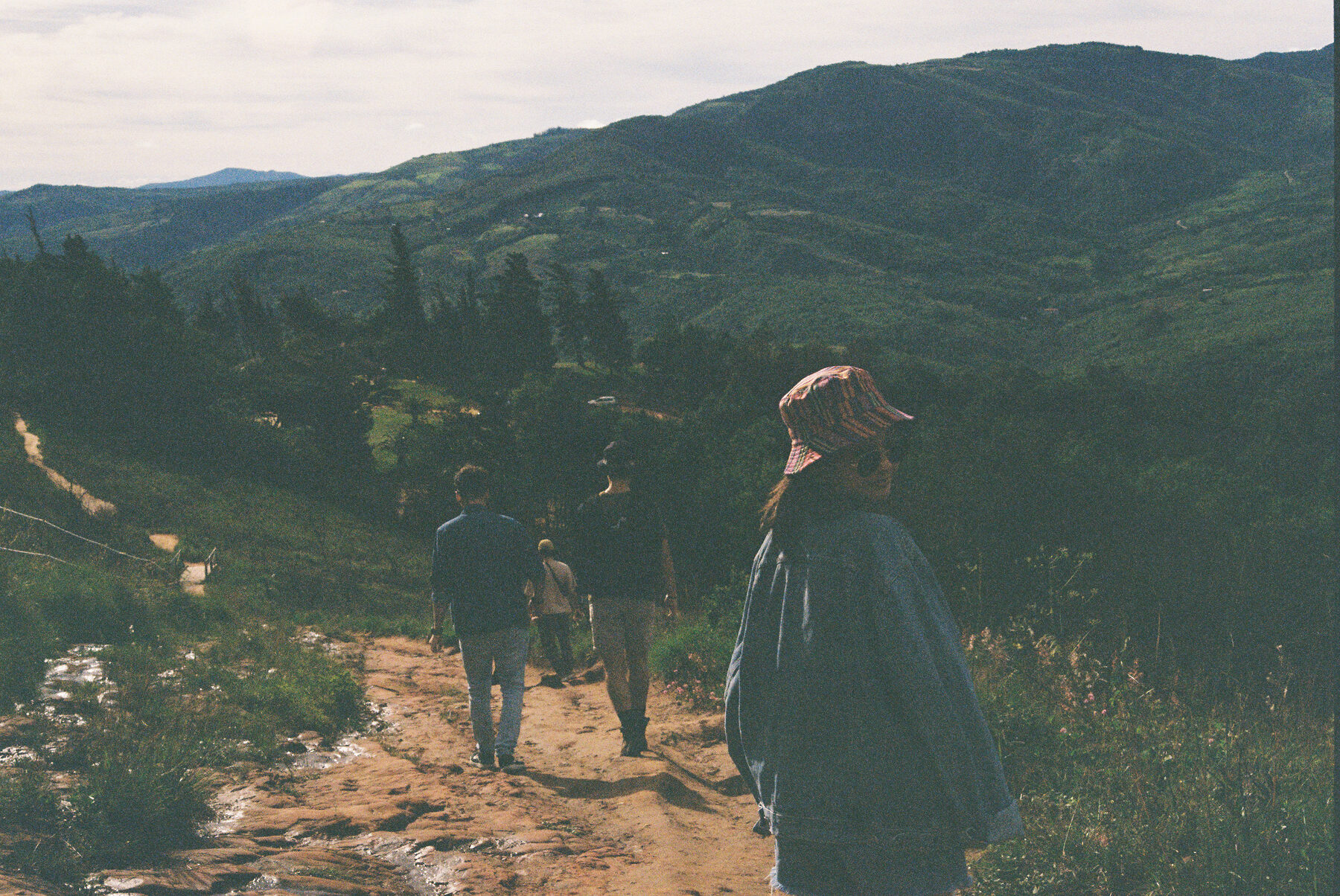 The group walking a ridge trail, hills falling away behind